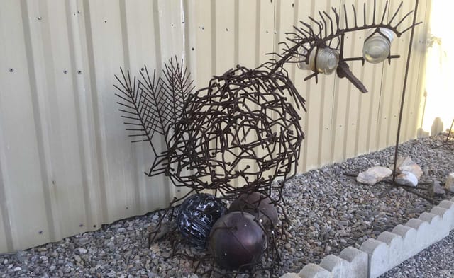 Chicken sculpture welded from horseshoes and nails