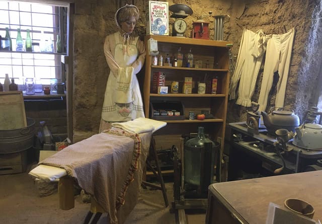 Pioneer kitchen display with a mannequin at an ironing board