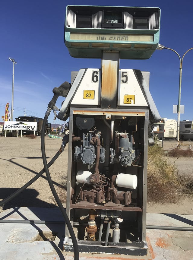 Vintage gas pump with a Johnson RV sign behind it
