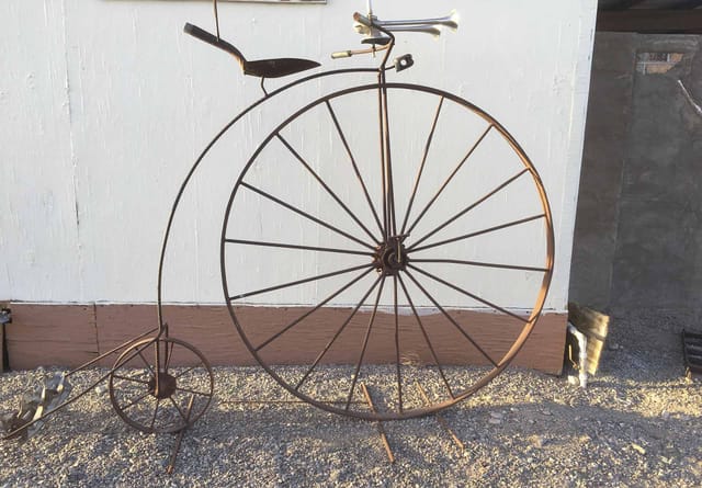 High-wheel bicycle sculpture made from scrap metal