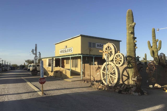 Hassler's RV Park office with wagon-wheel and horseshoe sculptures out front