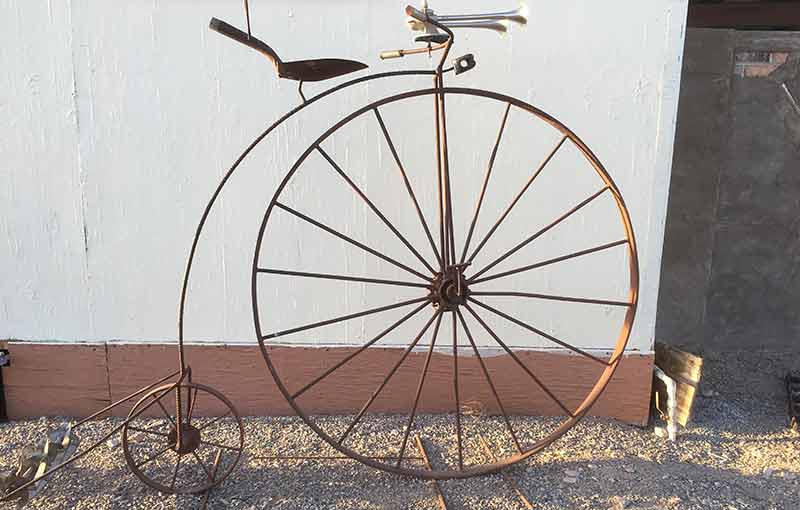 High-wheel bicycle sculpture made from scrap metal