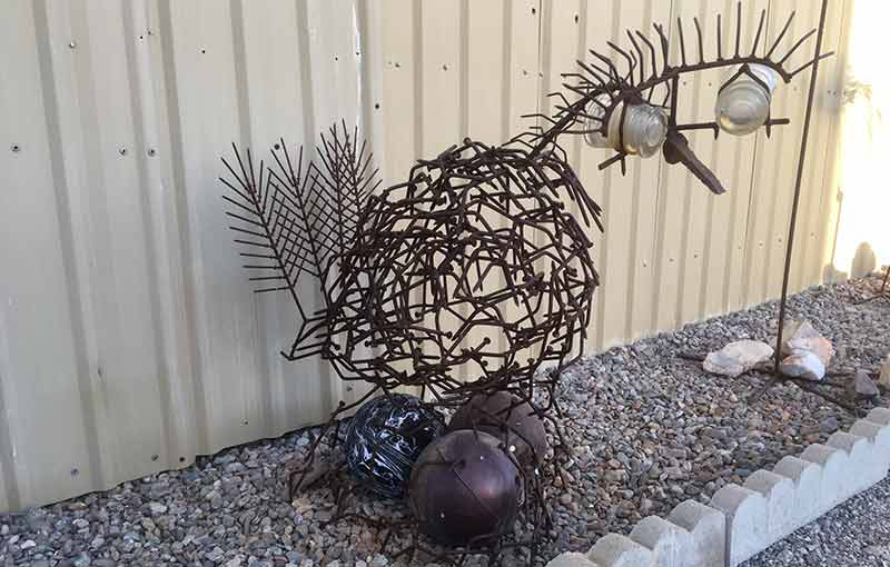 Chicken sculpture welded from horseshoes and nails